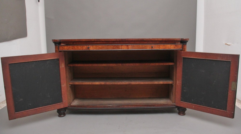 An early 19th-century Regency pollard oak side cabinet featuring two brass lattice grille doors, ebony stringing, and turned flanking columns. View II
