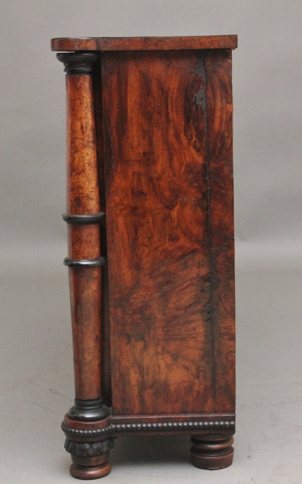 An early 19th-century Regency pollard oak side cabinet featuring two brass lattice grille doors, ebony stringing, and turned flanking columns. View VII