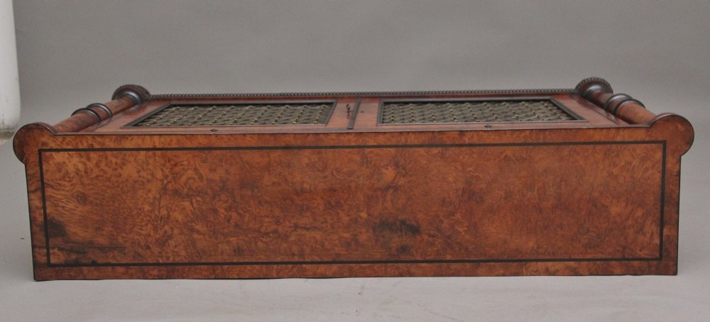 An early 19th-century Regency pollard oak side cabinet featuring two brass lattice grille doors, ebony stringing, and turned flanking columns. View VIII