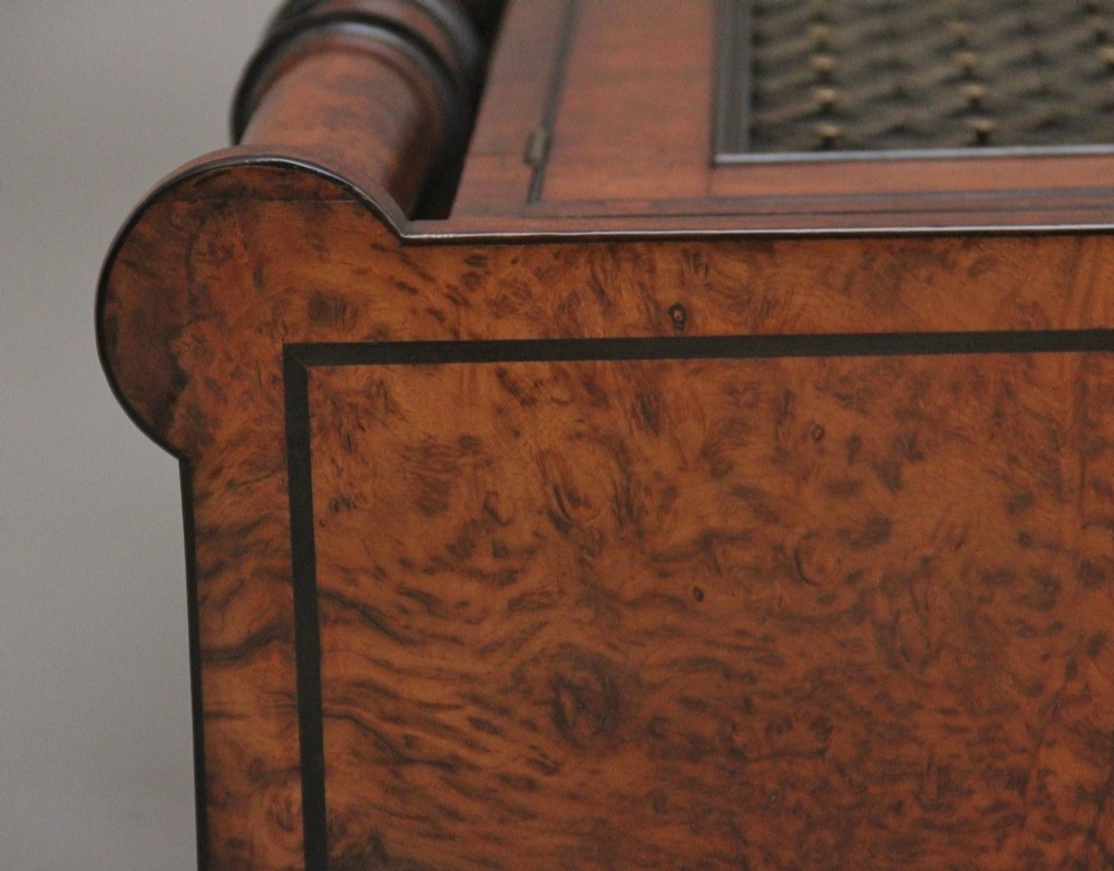 An early 19th-century Regency pollard oak side cabinet featuring two brass lattice grille doors, ebony stringing, and turned flanking columns. View IX