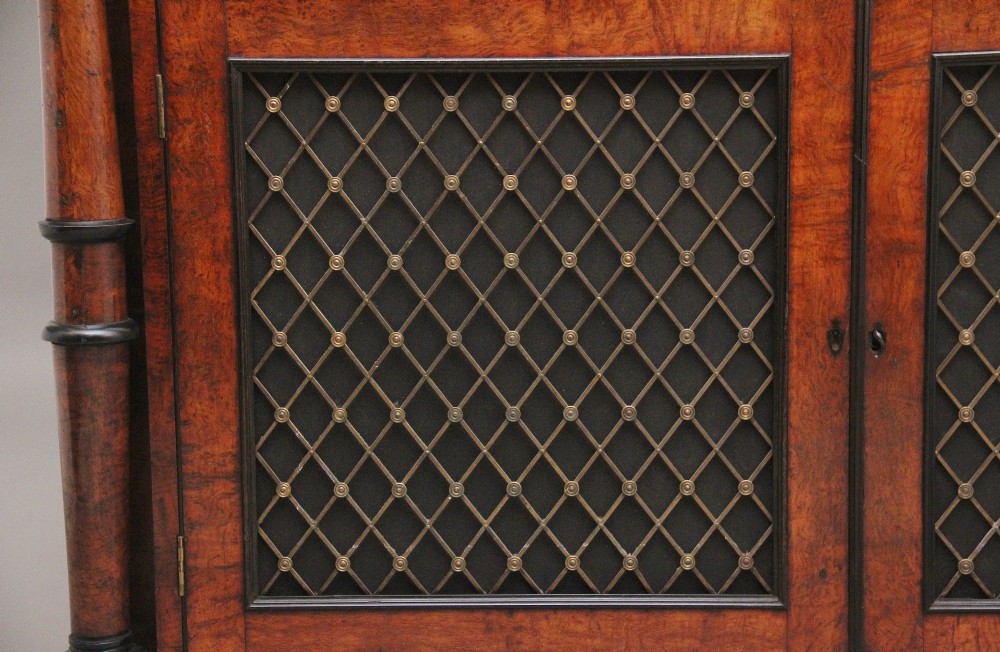An early 19th-century Regency pollard oak side cabinet featuring two brass lattice grille doors, ebony stringing, and turned flanking columns. View XIII