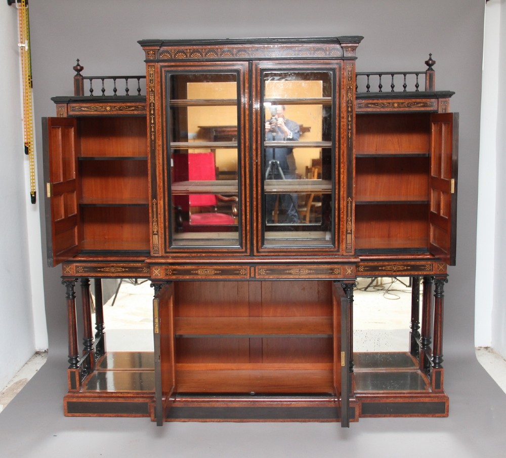 A large Victorian ebonised and walnut display cabinet with marquetry inlays, central glazed doors, and turned columns. View II