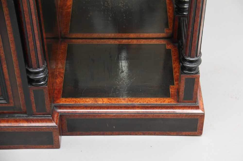 A large Victorian ebonised and walnut display cabinet with marquetry inlays, central glazed doors, and turned columns. View VI