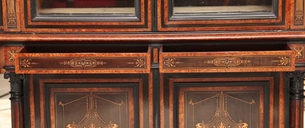 A large Victorian ebonised and walnut display cabinet with marquetry inlays, central glazed doors, and turned columns. View VIII