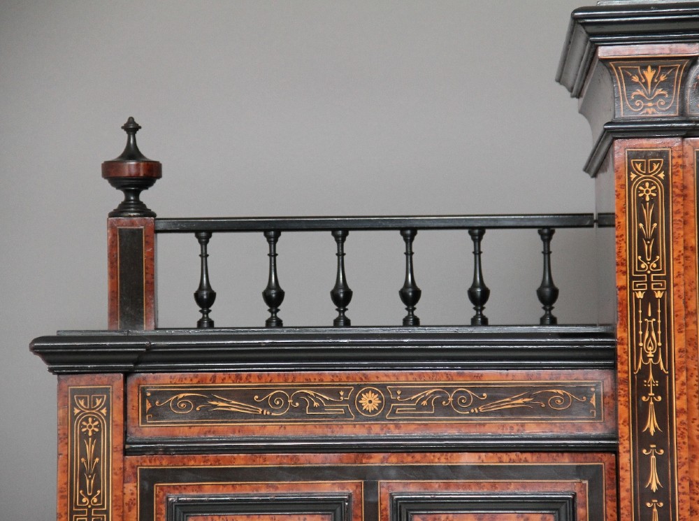 A large Victorian ebonised and walnut display cabinet with marquetry inlays, central glazed doors, and turned columns. View IX