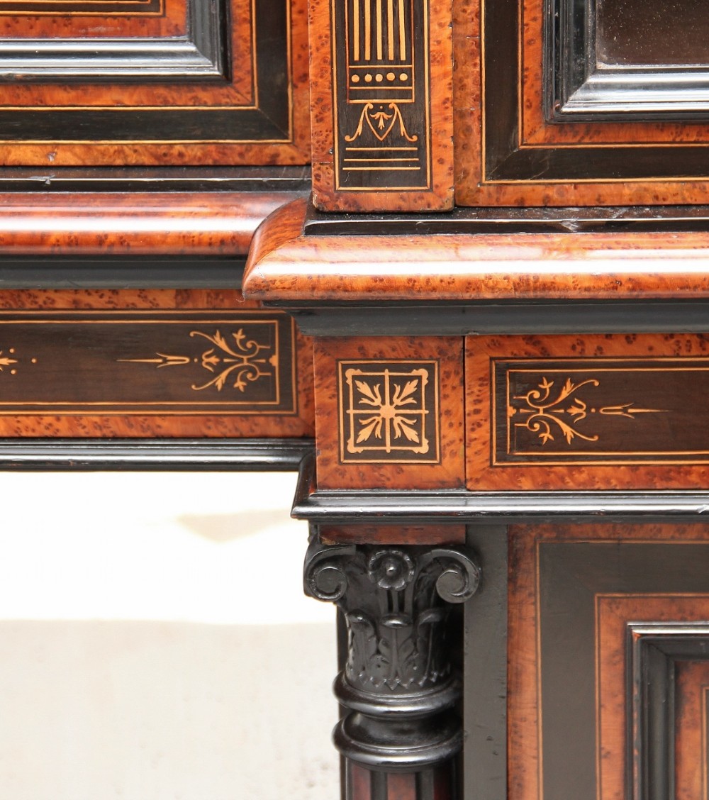 A large Victorian ebonised and walnut display cabinet with marquetry inlays, central glazed doors, and turned columns. View XI