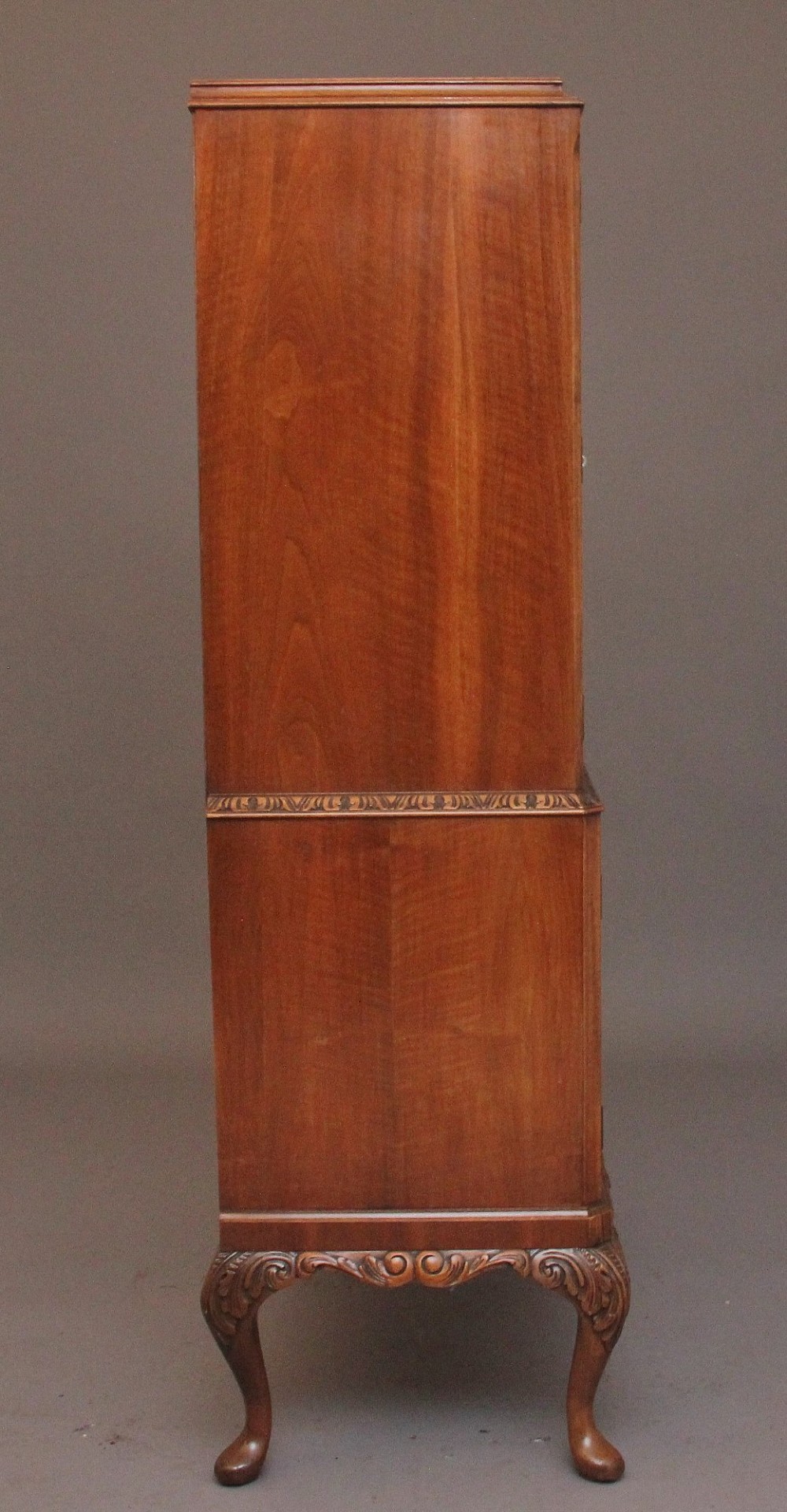 An early 20th-century burr walnut drinks cabinet with decorative pierced brass strap hinges, double doors, and carved cabriole legs. View XI