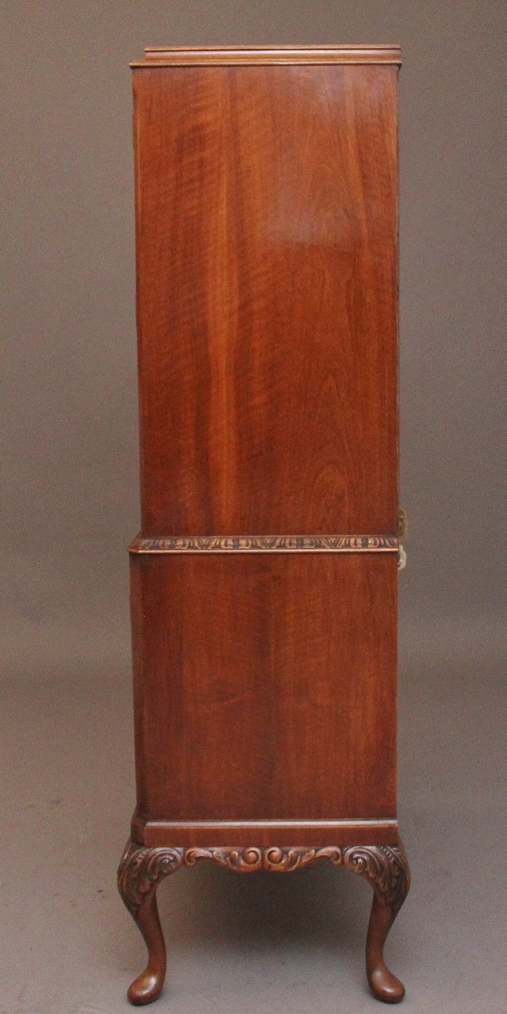An early 20th-century burr walnut drinks cabinet with decorative pierced brass strap hinges, double doors, and carved cabriole legs. View XIII
