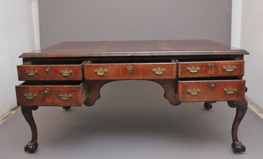 A 19th-century walnut writing desk featuring multiple drawers with brass hardware, a shaped apron, and carved cabriole legs with ball-and-claw feet. View II