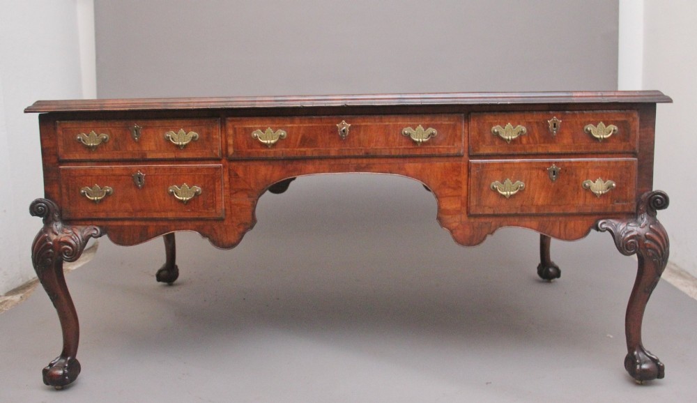 A 19th-century walnut writing desk featuring multiple drawers with brass hardware, a shaped apron, and carved cabriole legs with ball-and-claw feet. View III