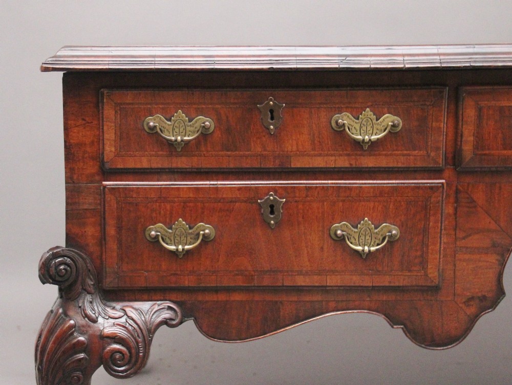 A 19th-century walnut writing desk featuring multiple drawers with brass hardware, a shaped apron, and carved cabriole legs with ball-and-claw feet. View IV