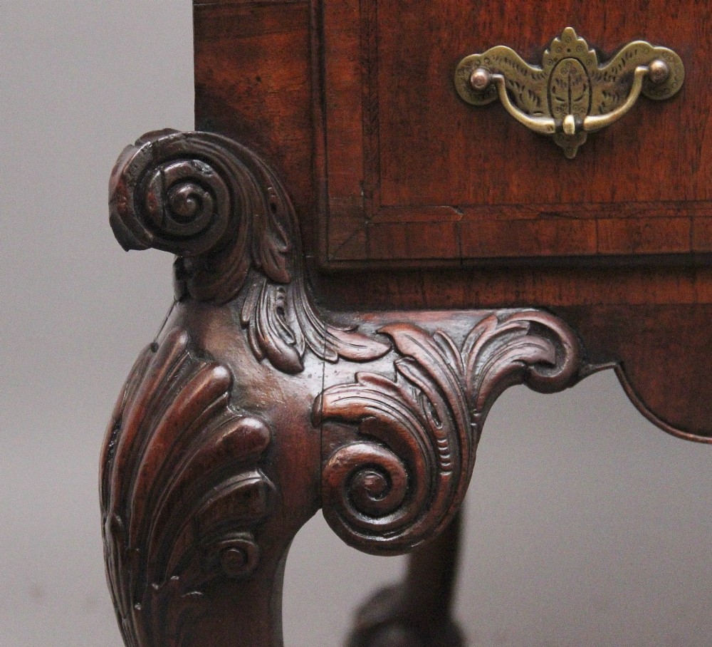 A 19th-century walnut writing desk featuring multiple drawers with brass hardware, a shaped apron, and carved cabriole legs with ball-and-claw feet. View V
