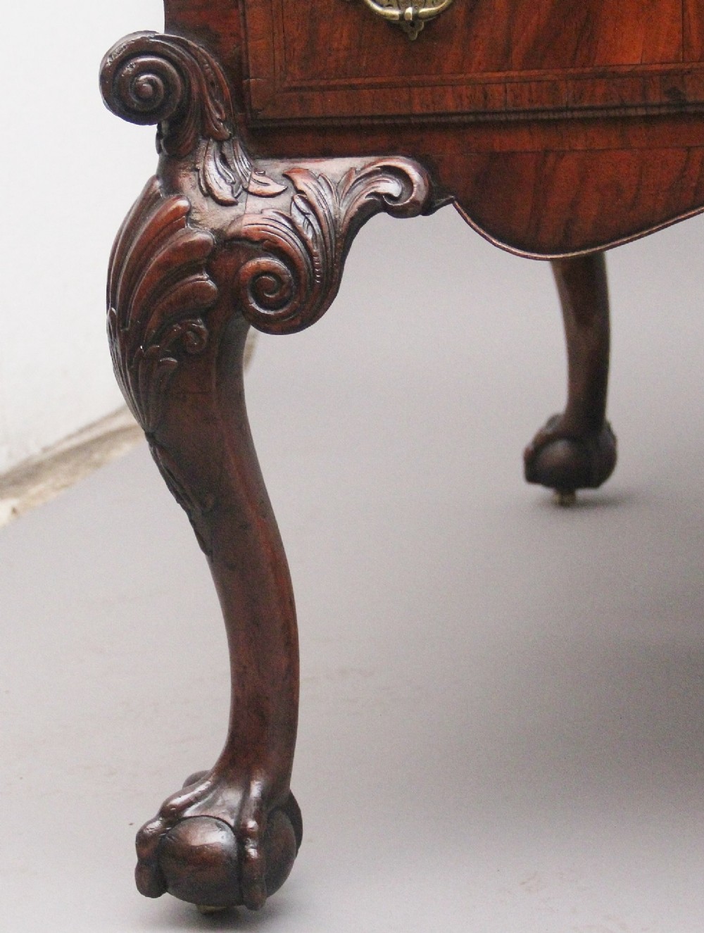 A 19th-century walnut writing desk featuring multiple drawers with brass hardware, a shaped apron, and carved cabriole legs with ball-and-claw feet. View VII