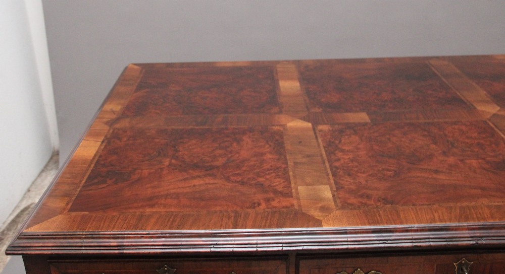 A 19th-century walnut writing desk featuring multiple drawers with brass hardware, a shaped apron, and carved cabriole legs with ball-and-claw feet. View IX