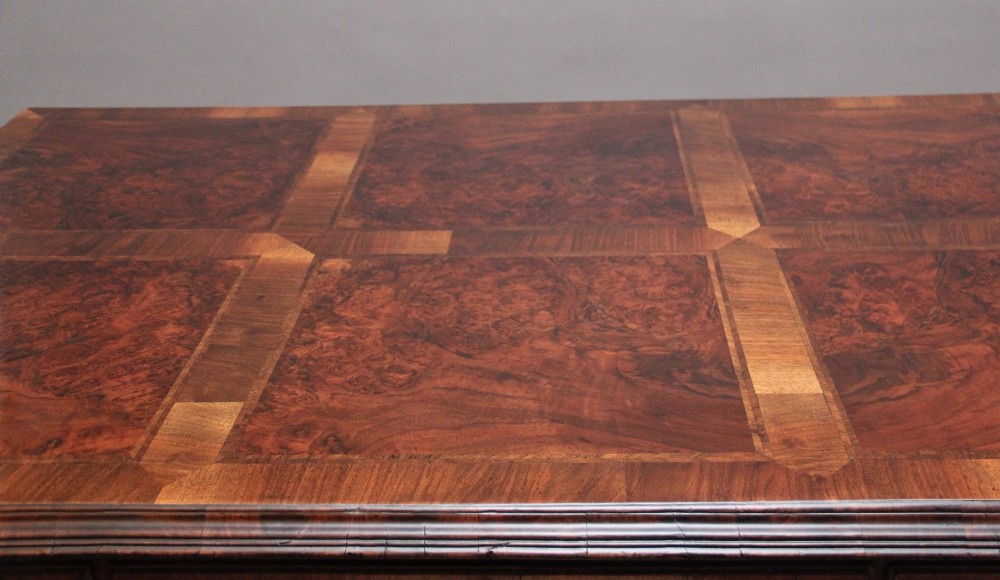 A 19th-century walnut writing desk featuring multiple drawers with brass hardware, a shaped apron, and carved cabriole legs with ball-and-claw feet. View X