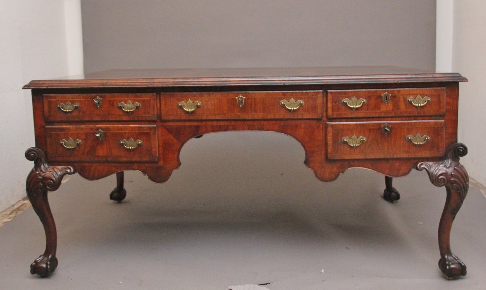 A 19th-century walnut writing desk featuring multiple drawers with brass hardware, a shaped apron, and carved cabriole legs with ball-and-claw feet. View XIII