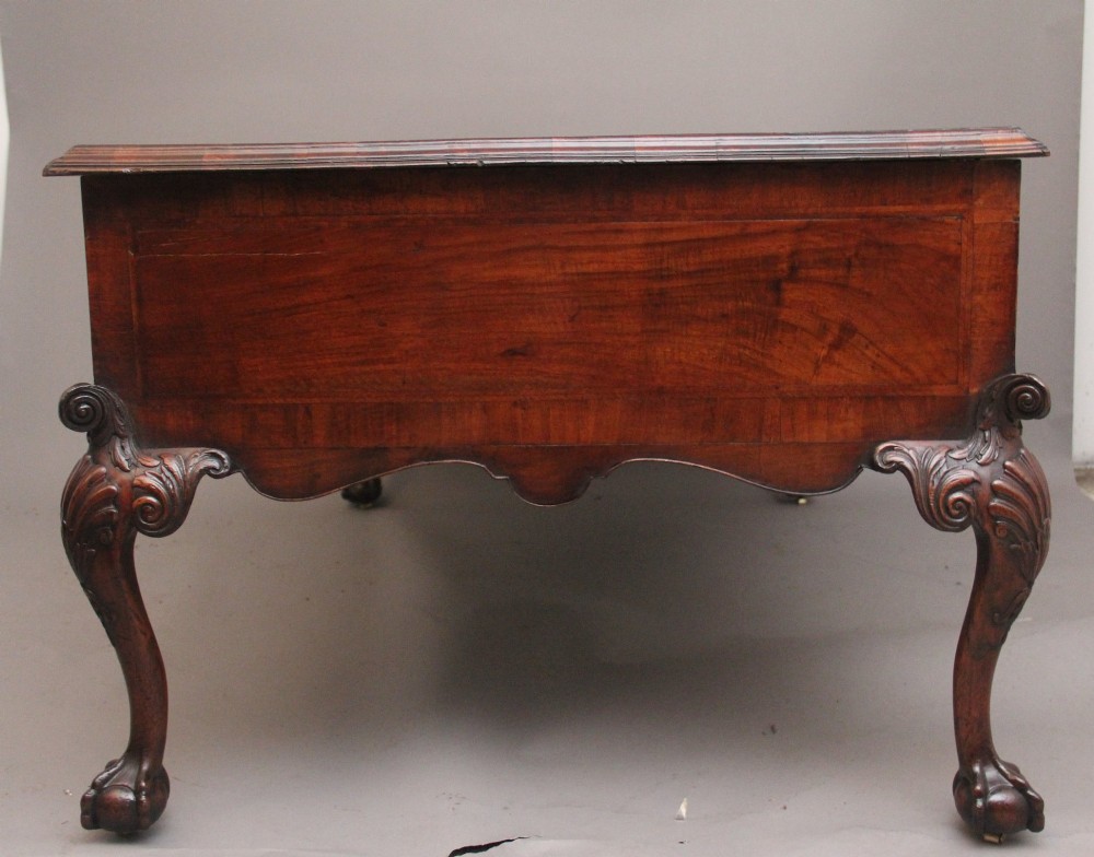 A 19th-century walnut writing desk featuring multiple drawers with brass hardware, a shaped apron, and carved cabriole legs with ball-and-claw feet. View XV