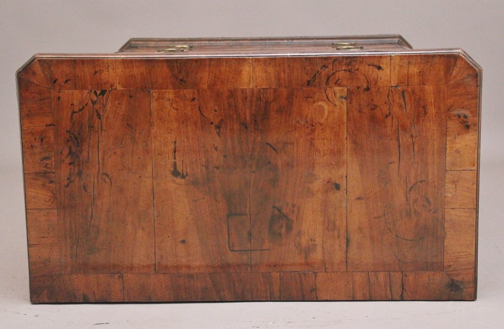 An early 18th-century George II walnut chest of drawers featuring crossbanded drawer fronts, brass handles, a central cupboard door, and bracket feet. View XI