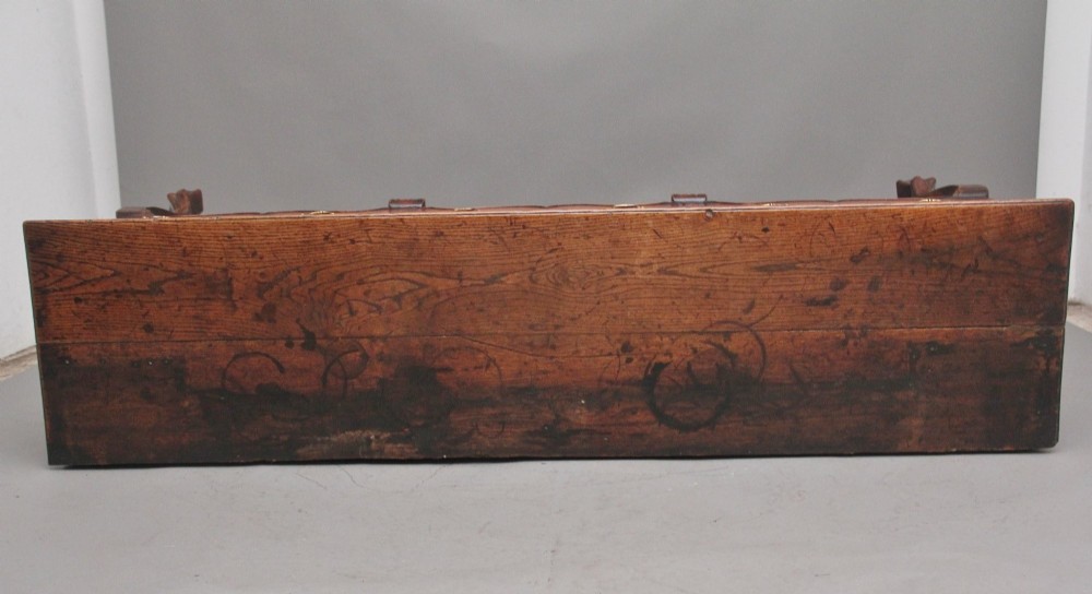 An early 18th-century oak dresser base featuring three brass-handled drawers, a scalloped apron with pendant drops, and cabriole legs. View X