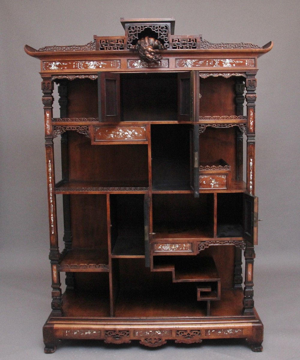 A dark brown 19th-century French Japonisme shodona display cabinet featuring mother-of-pearl inlays, asymmetrical shelves, and a carved pagoda crest with a dragon detail. View II