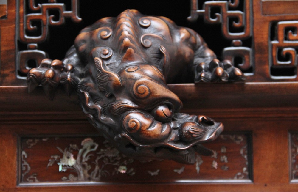 A dark brown 19th-century French Japonisme shodona display cabinet featuring mother-of-pearl inlays, asymmetrical shelves, and a carved pagoda crest with a dragon detail. View V