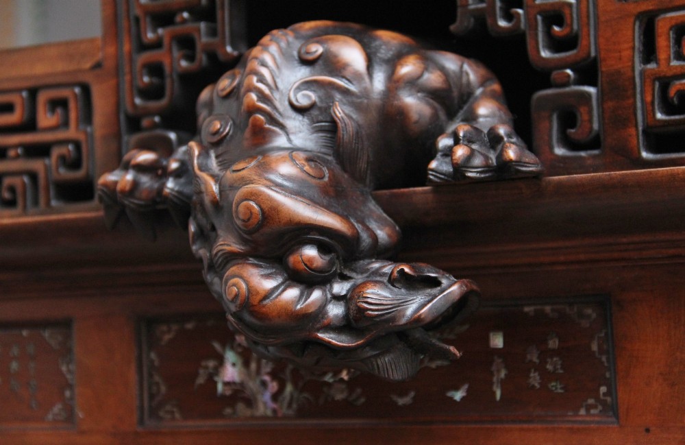 A dark brown 19th-century French Japonisme shodona display cabinet featuring mother-of-pearl inlays, asymmetrical shelves, and a carved pagoda crest with a dragon detail. View VI