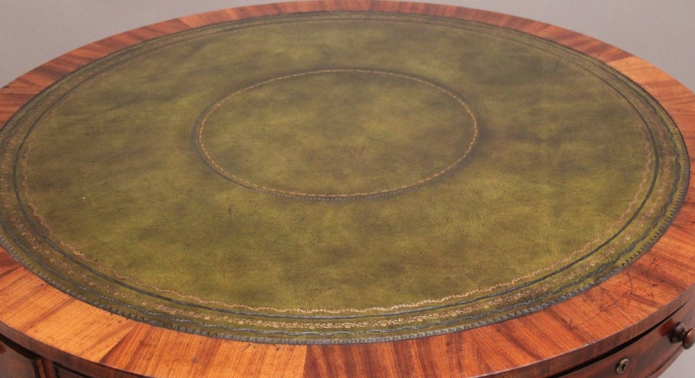 An early 19th century circular mahogany drum table featuring an inset green leather top, frieze drawers with knob handles, and a turned pedestal base. View III