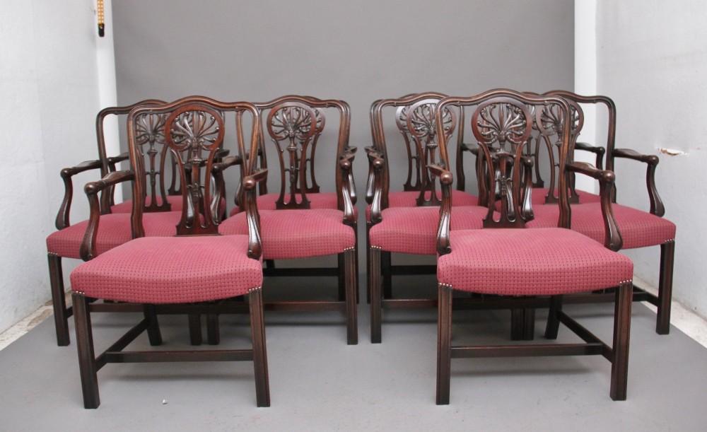 A set of ten dark mahogany armchairs featuring carved anthemion splats and red patterned upholstered seats. View II
