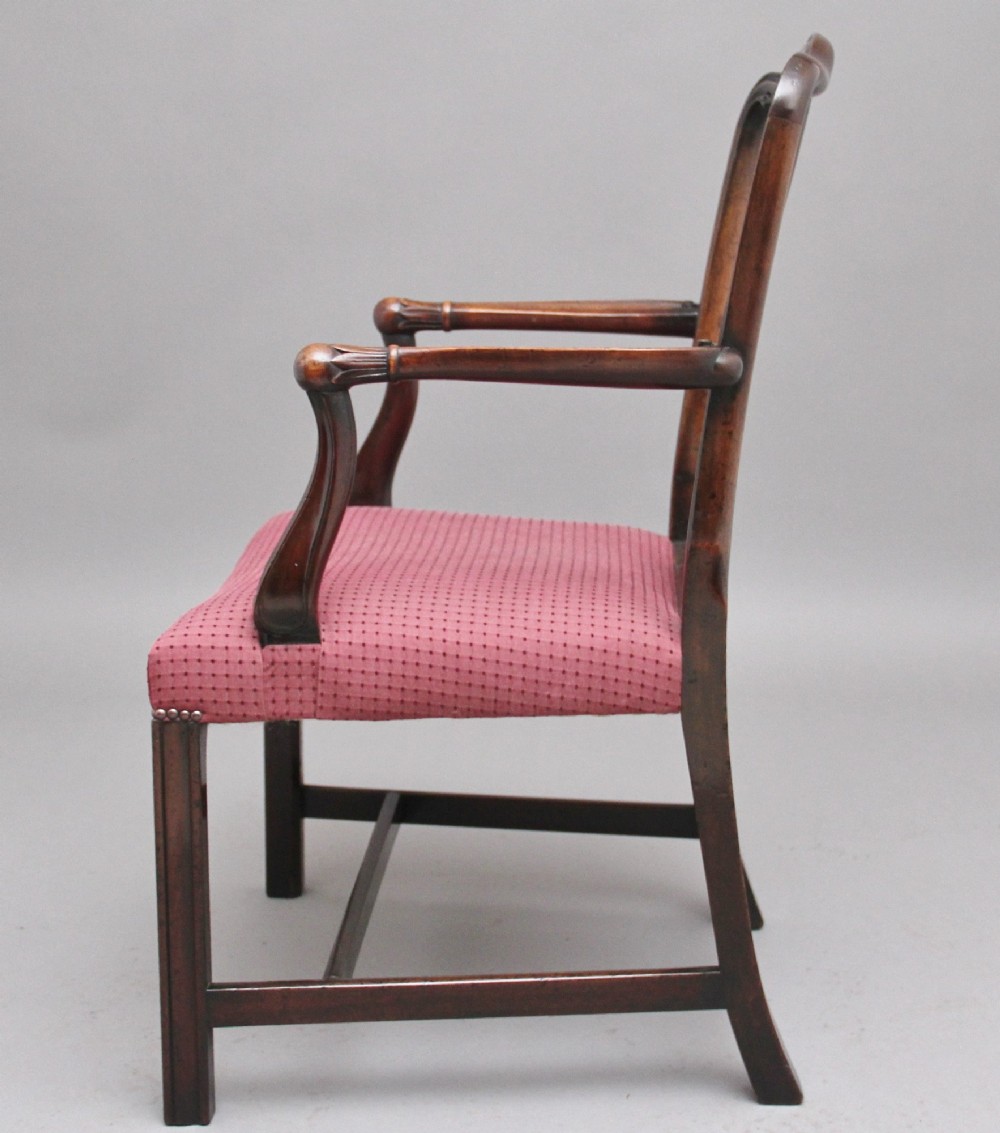 A set of ten dark mahogany armchairs featuring carved anthemion splats and red patterned upholstered seats. View VI