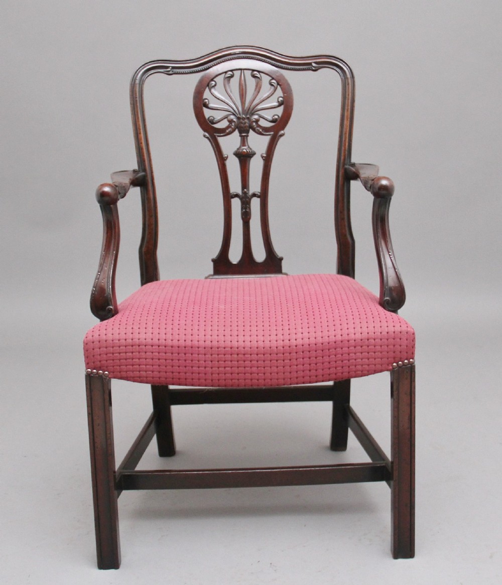 A set of ten dark mahogany armchairs featuring carved anthemion splats and red patterned upholstered seats. View VII