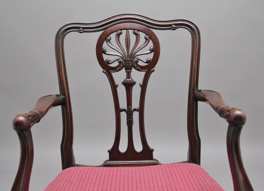 A set of ten dark mahogany armchairs featuring carved anthemion splats and red patterned upholstered seats. View VIII