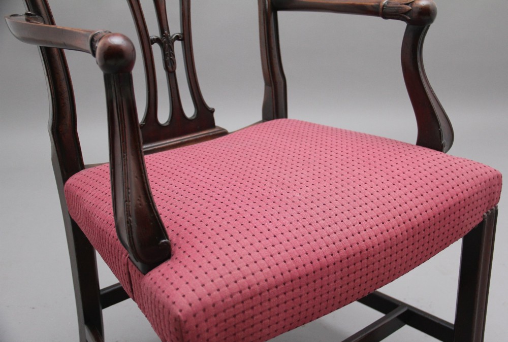 A set of ten dark mahogany armchairs featuring carved anthemion splats and red patterned upholstered seats. View X