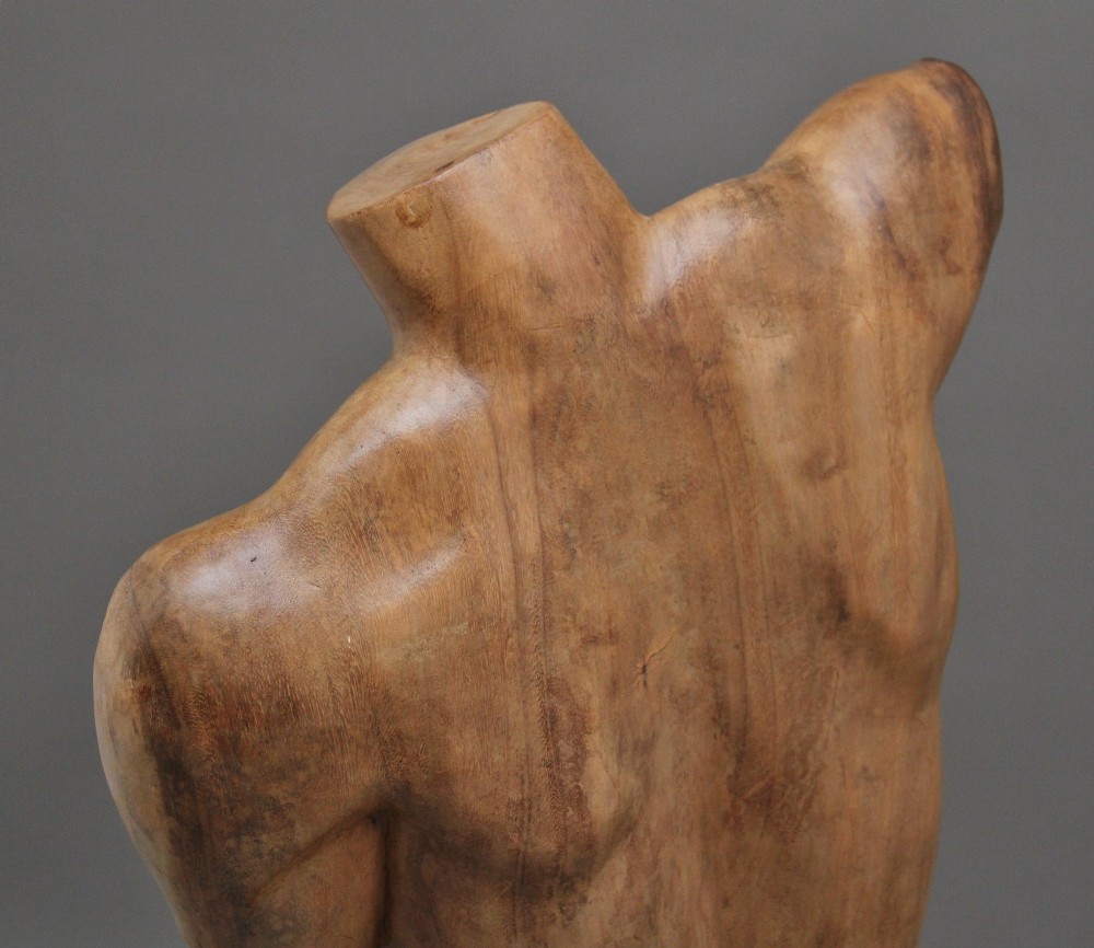 A life-size early twentieth-century sculpture of a female torso carved from natural timber with visible wood grain and a smooth finish. View XIII