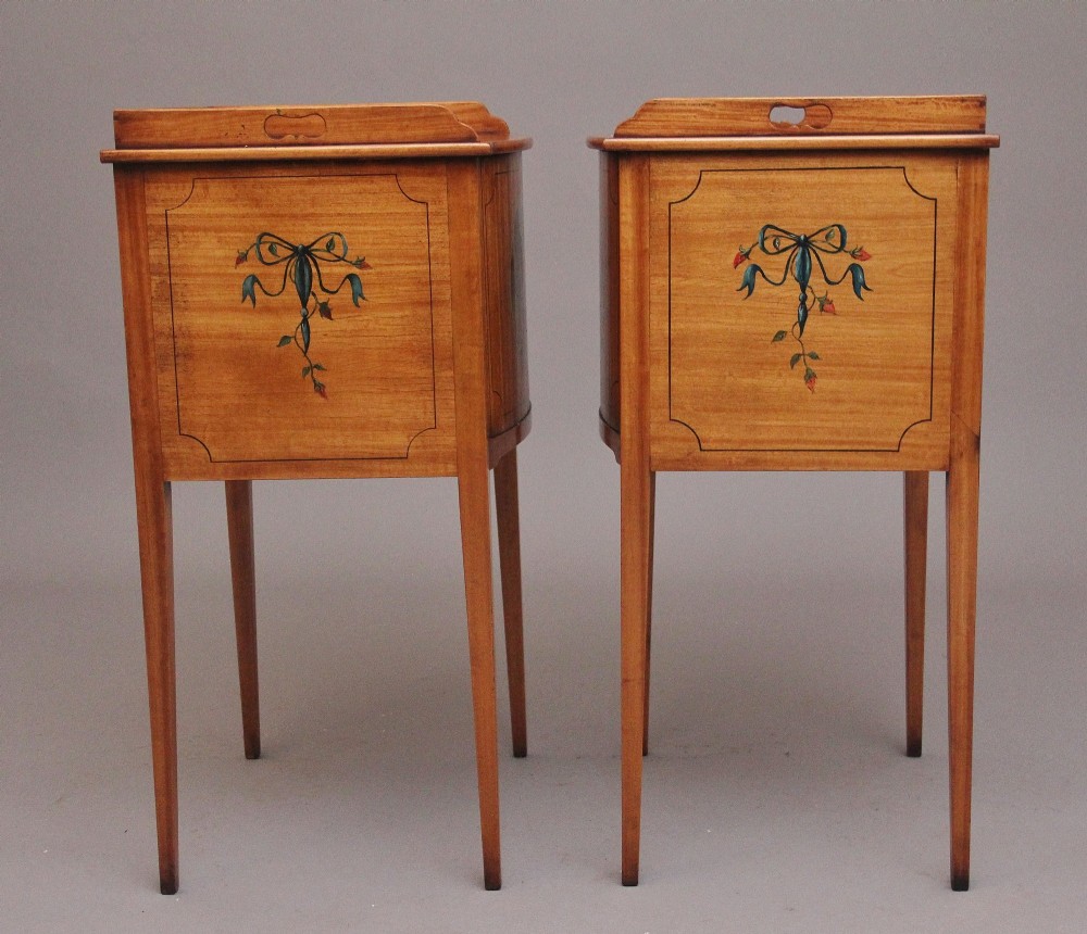 A pair of tall early 20th-century satinwood bedside cabinets featuring hand-painted classical figural medallions and tapered square legs. View VII
