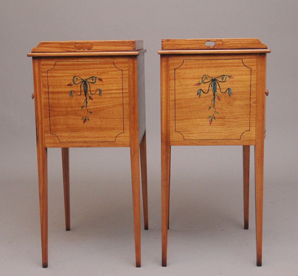 A pair of tall early 20th-century satinwood bedside cabinets featuring hand-painted classical figural medallions and tapered square legs. View IX