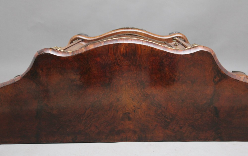 A Victorian burr walnut credenza featuring central floral marquetry, curved side glass doors, and gilt metal mounts. View V