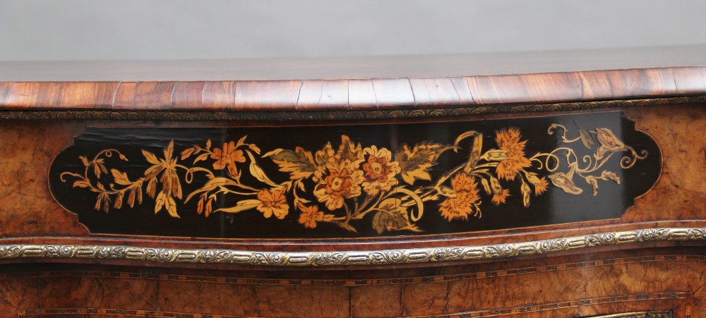 A Victorian burr walnut credenza featuring central floral marquetry, curved side glass doors, and gilt metal mounts. View XIII