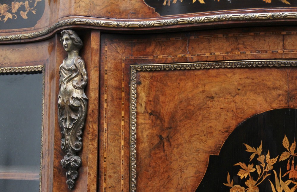 A Victorian burr walnut credenza featuring central floral marquetry, curved side glass doors, and gilt metal mounts. View XIV