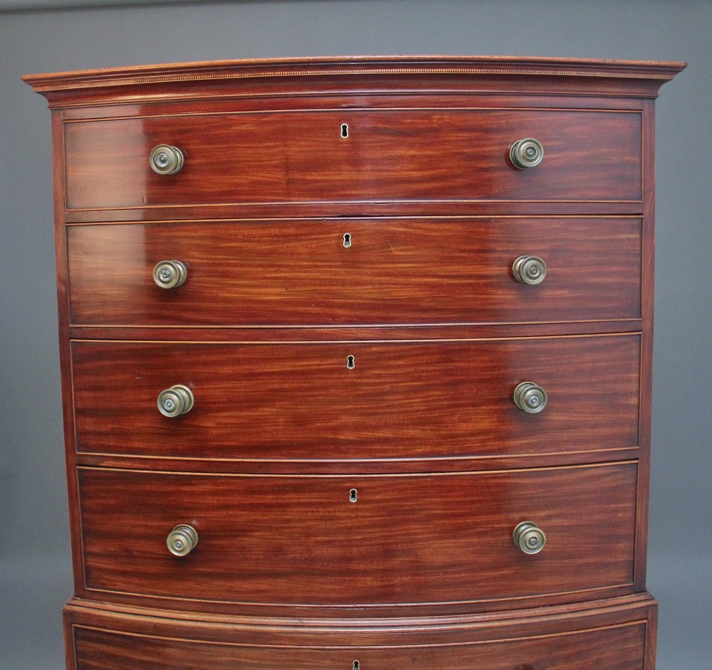 An early nineteenth-century mahogany bow-front tallboy featuring seven stacked drawers with turned brass handles. View III
