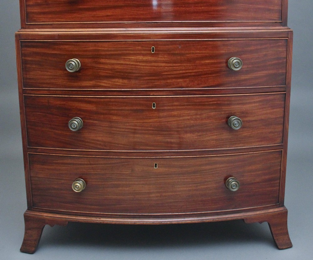 An early nineteenth-century mahogany bow-front tallboy featuring seven stacked drawers with turned brass handles. View IV
