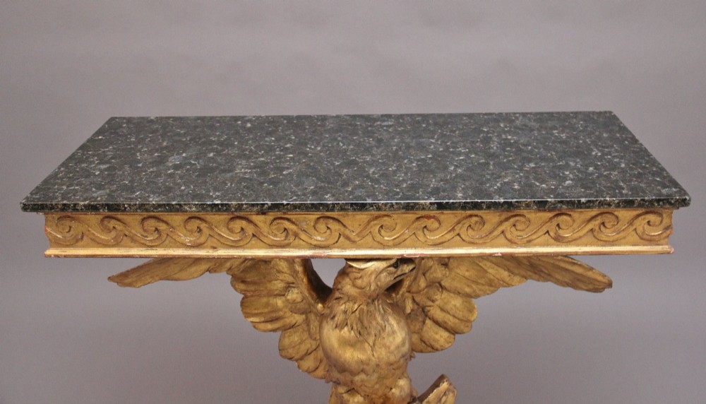An early 20th-century Neoclassical style console table featuring a sculpted gold eagle base supporting a dark green marble tabletop. View III