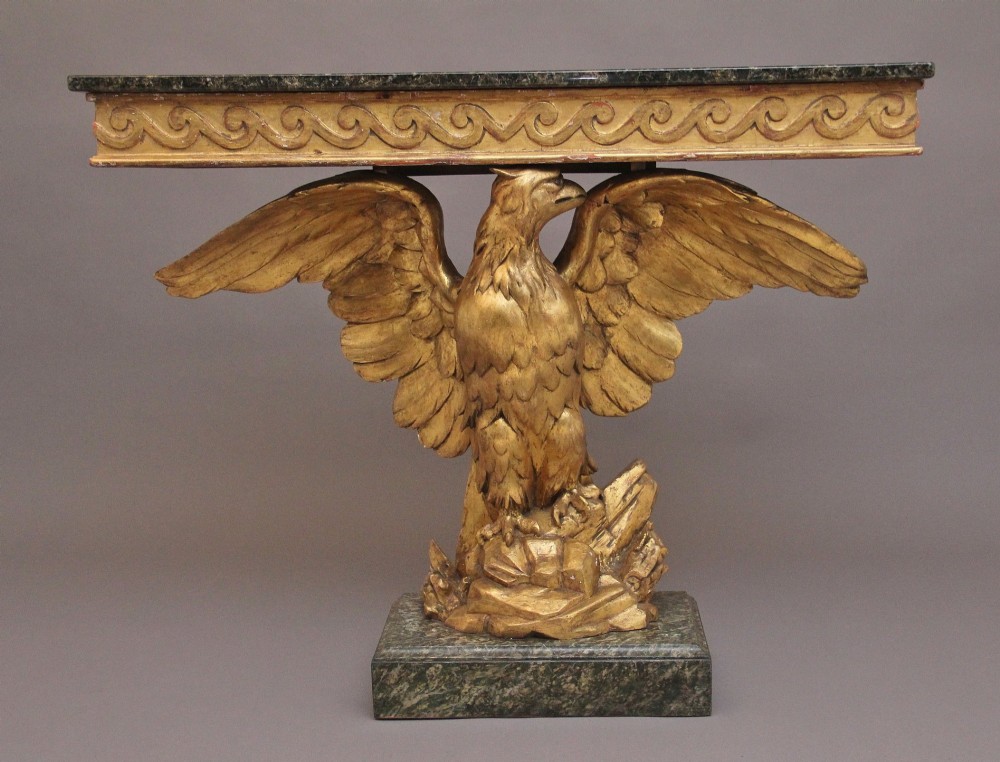 An early 20th-century Neoclassical style console table featuring a sculpted gold eagle base supporting a dark green marble tabletop. View IV