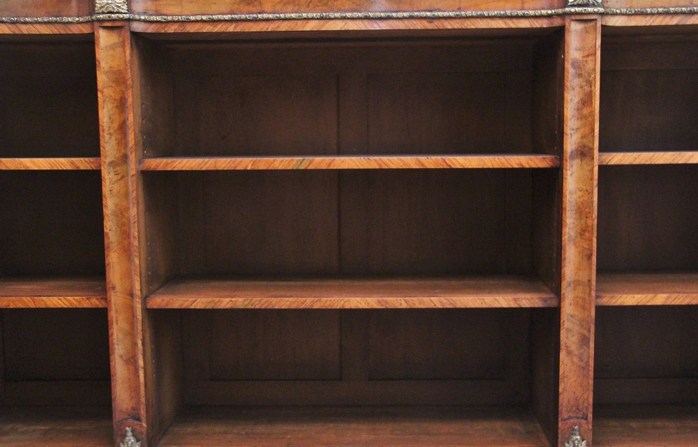 A nineteenth-century low breakfront open bookcase crafted from burr walnut with gilt-bronze ormolu mounts along the top border and base. View IV