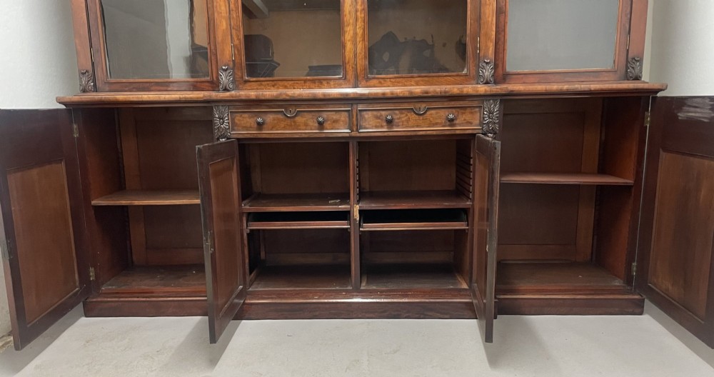 An early nineteenth-century mahogany breakfront bookcase featuring four glazed upper doors over four panelled lower cupboard doors. View IV