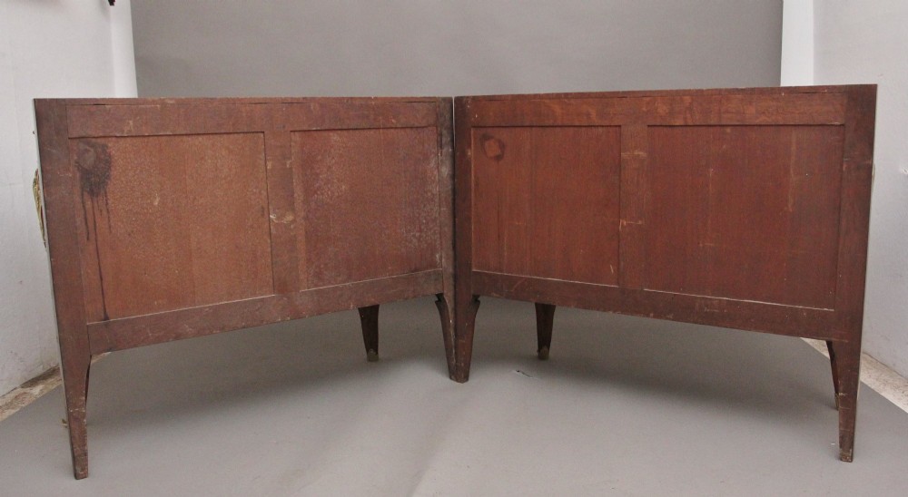 A pair of 19th-century French kingwood commodes featuring chevron parquetry veneer, mottled brown marble tops, and decorative gilt-bronze mounts. View VI