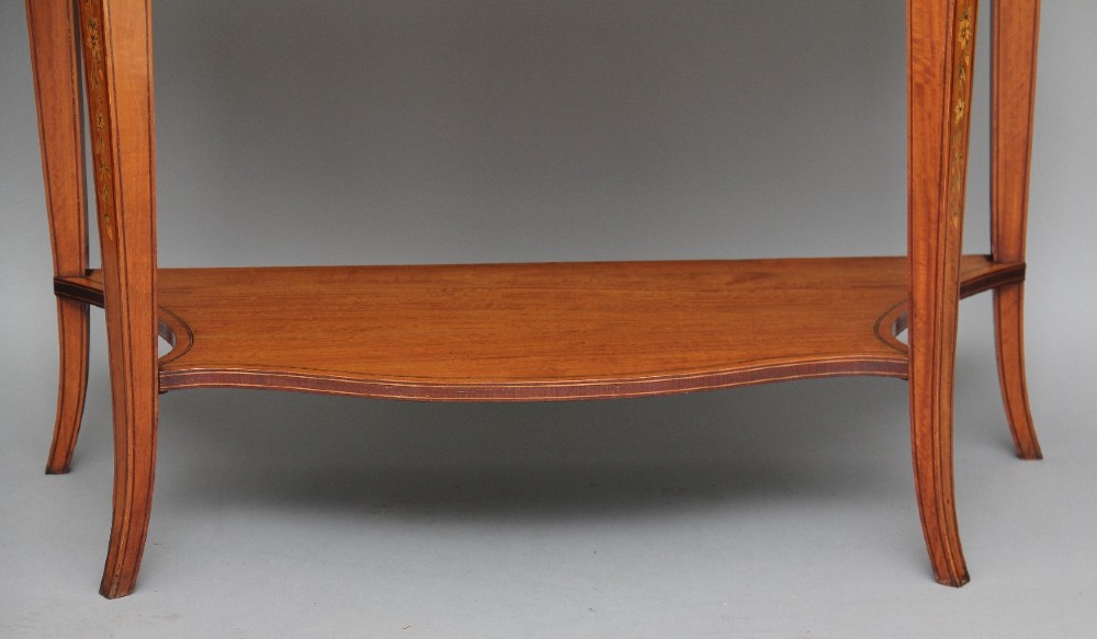 A 19th-century satinwood display cabinet featuring a swan-neck pediment, curved central glass door, and marquetry inlaid lower doors on square tapered legs. View XIII