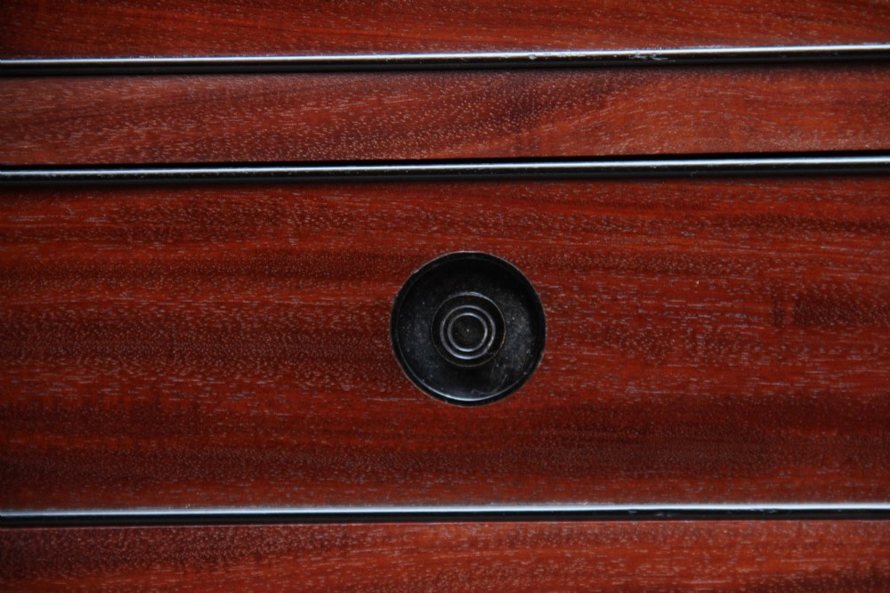 An early nineteenth-century flame mahogany collectors cabinet on stand featuring twin panelled doors above a single drawer and turned reeded legs. View IX