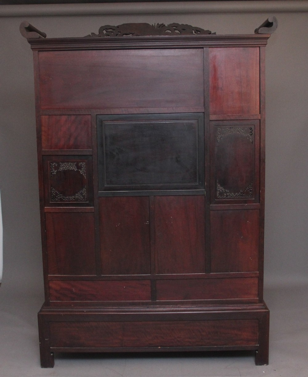 A large 19th-century Japanese Shodona display cabinet featuring multi-tiered asymmetrical shelves, carved dragon cresting, and mother-of-pearl inlaid doors depicting nature scenes. View VII