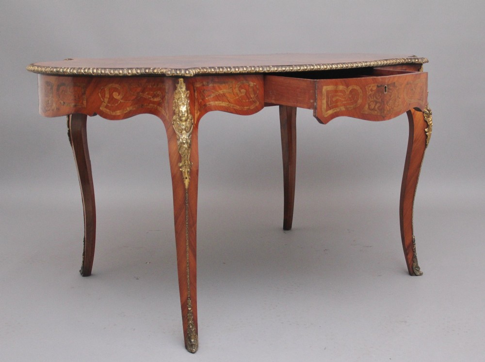 A 19th-century French style walnut centre table featuring elaborate marquetry inlay, a serpentine apron, cabriole legs, and ornate gilt bronze mounts. View III
