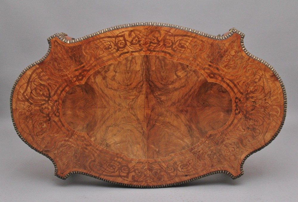 A 19th-century French style walnut centre table featuring elaborate marquetry inlay, a serpentine apron, cabriole legs, and ornate gilt bronze mounts. View VII